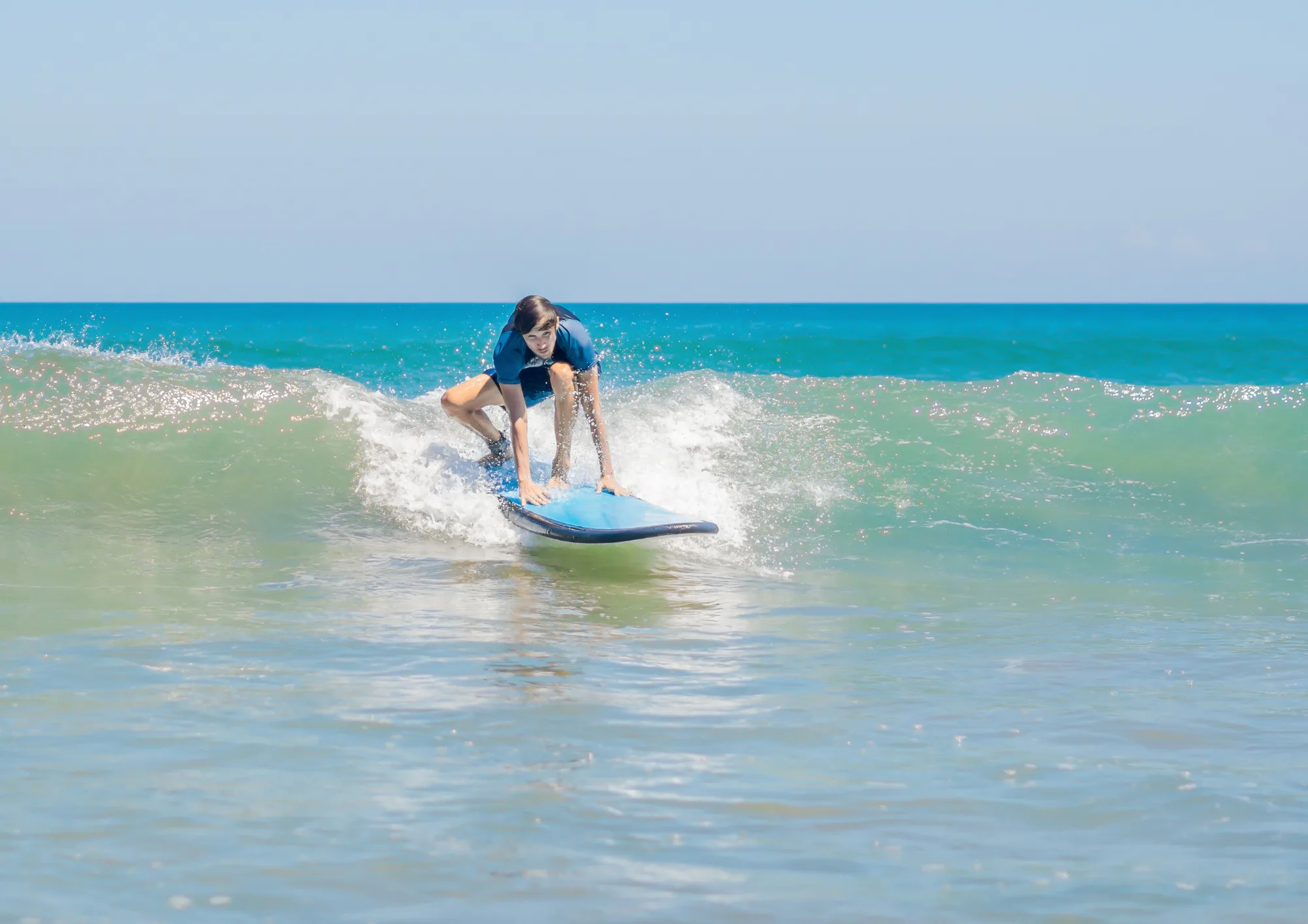 Principiante cogiendo una ola en Fuerteventura